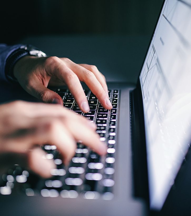 typing-at-computer-at-night